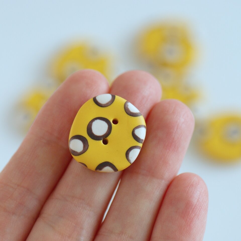 21 mm – 9 vnt. netaisyklingos apvalaino keturkampio formos geltonos taškuotos sagos